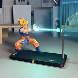 Figurine Dragon Ball Z Son Goku kamehameha magnétique posé sur un bureau devant des livres